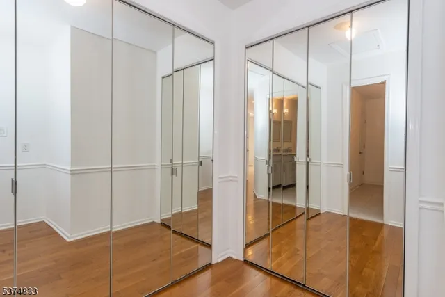 a bathroom with a granite countertop sink a mirror and shower
