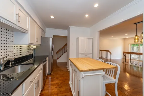 a kitchen with stainless steel appliances sink microwave and stove