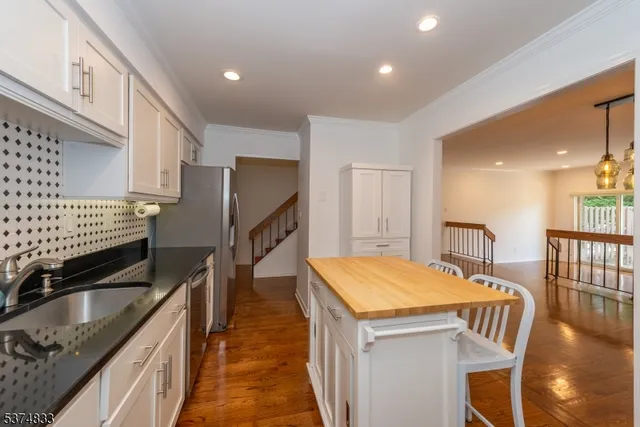 a kitchen with stainless steel appliances sink microwave and stove