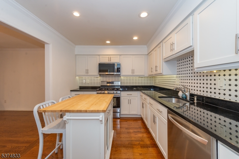 3 Avery Court Madison, NJ 07940 - Photo 7 of 50 a kitchen with stainless steel appliances sink microwave and stove