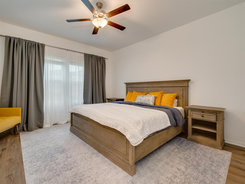 1208 Sweetspire Street Leander, TX 78641 - Photo 20 of 36 Spacious room featuring wood-finish flooring, a ceiling fan with integrated lighting, and a large window with privacy and blackout drapery