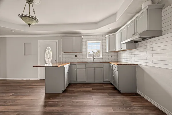 a kitchen with a sink cabinets and window