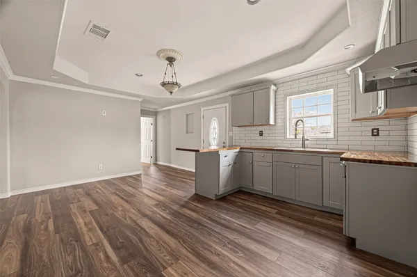 a kitchen with a sink window and cabinets