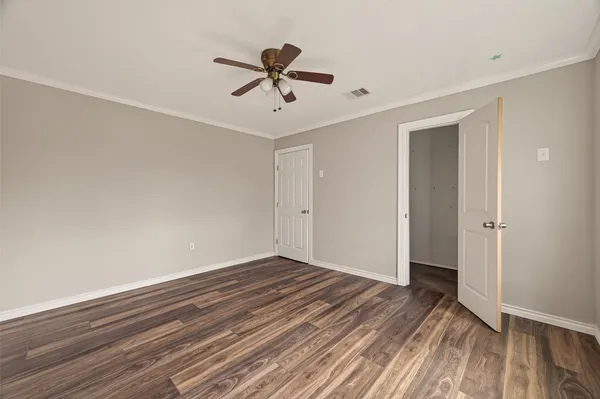 a view of room with hardwood floor and ceiling fan