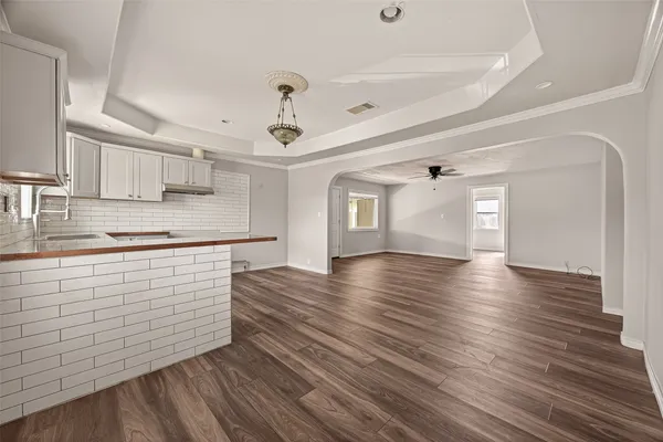 a view of kitchen with sink and wooden floor