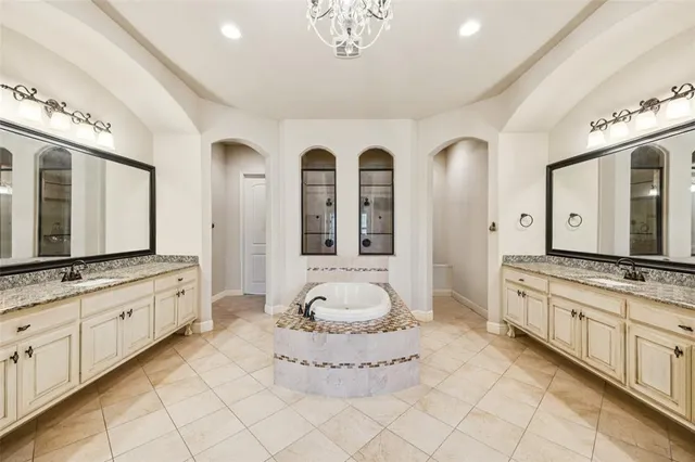a spacious bathroom with a granite countertop sink mirror and a