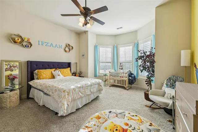 a bedroom with a bed and a couch