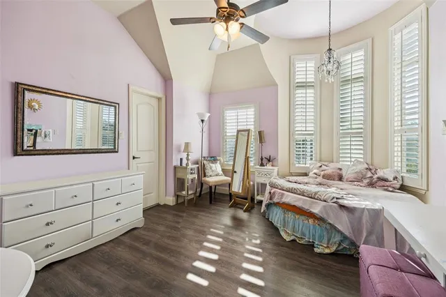 a spacious bedroom with a bed and a large window