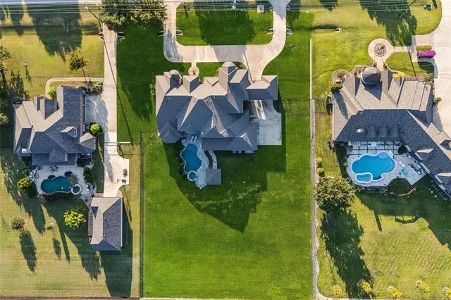 an aerial view of houses with yard