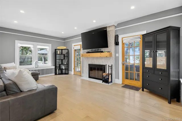 a living room with furniture a flat screen tv and a fireplace