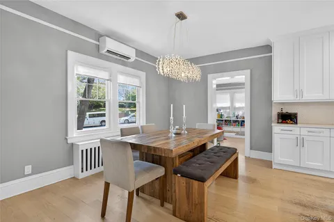 a dining room with a table chairs and chandelier