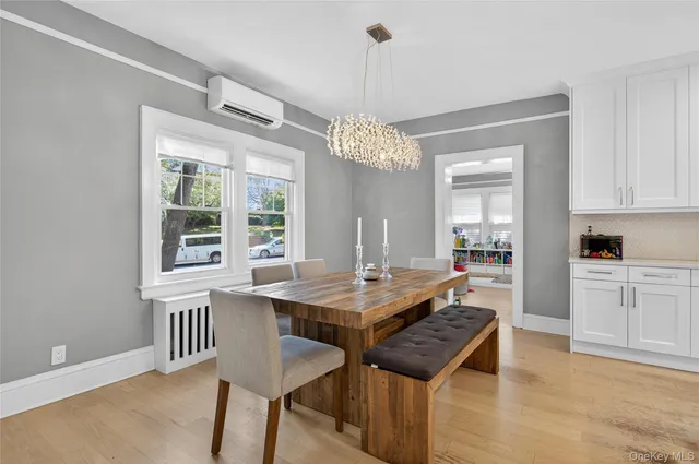 a dining room with a table chairs and chandelier