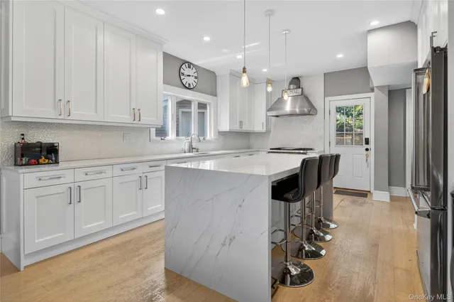 a kitchen with a sink appliances and cabinets