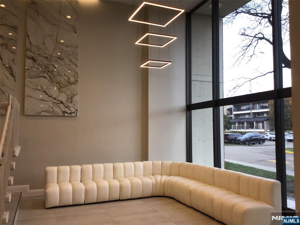 1203 River Road, Unit 21M Edgewater, NJ 07020 - Photo 11 of 12 a living room with a couch