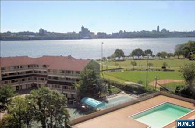 1203 River Road, Unit 21M Edgewater, NJ 07020 - Photo 2 of 12 a view of a lake with a mountain in the background