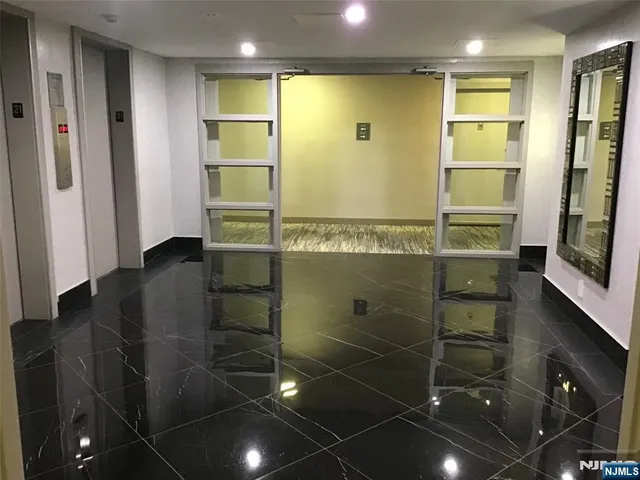 a bathroom with a shower and a mirror