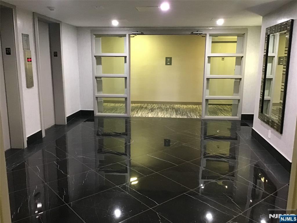 1203 River Road, Unit 21M Edgewater, NJ 07020 - Photo 8 of 12 a bathroom with a shower and a mirror