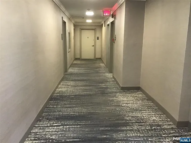 a view of hallway with a rug