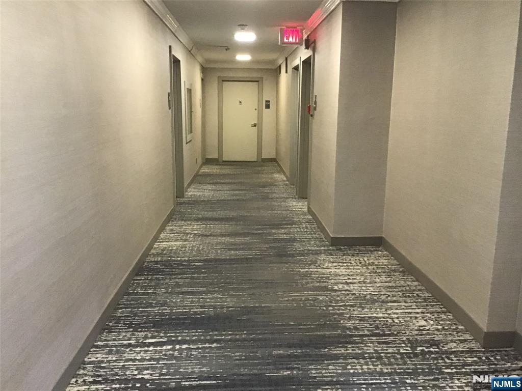 1203 River Road, Unit 21M Edgewater, NJ 07020 - Photo 9 of 12 a view of hallway with a rug