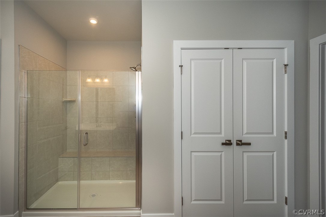 4100 Maze Runner Drive, Unit 406 Midlothian, VA 23112 - Photo 12 of 34 a bathroom with a glass shower door