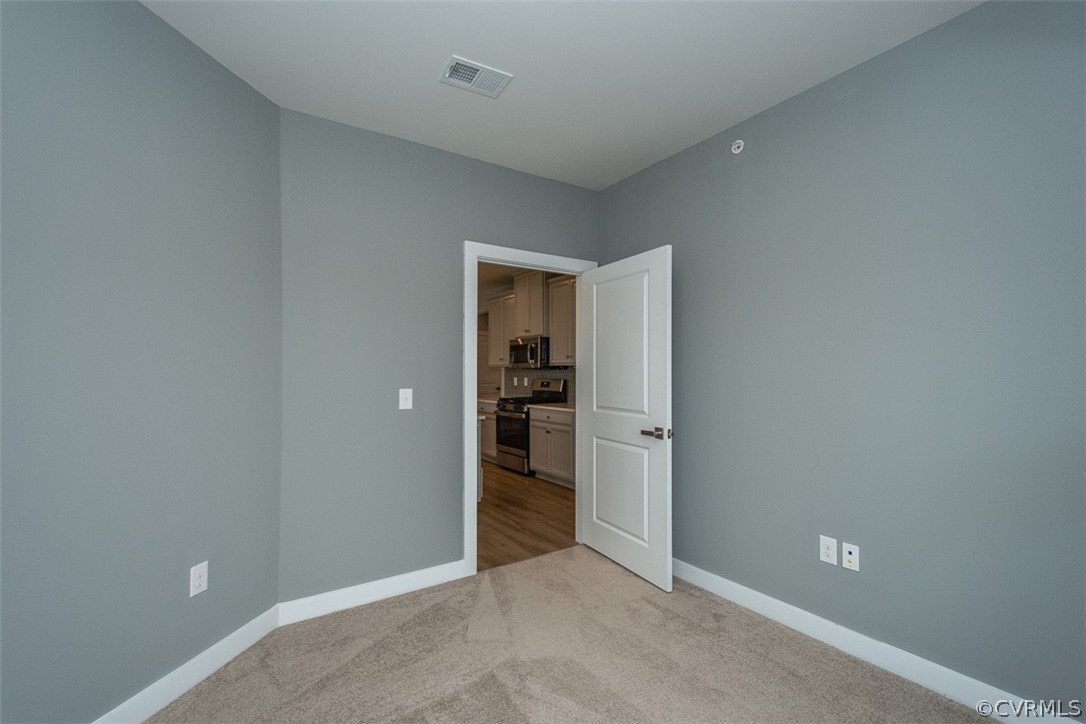 4100 Maze Runner Drive, Unit 406 Midlothian, VA 23112 - Photo 16 of 34 an empty room with closet and bathroom