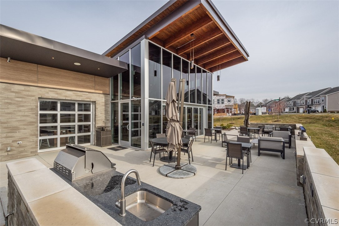 4100 Maze Runner Drive, Unit 406 Midlothian, VA 23112 - Photo 27 of 34 a roof deck with couches and potted plants