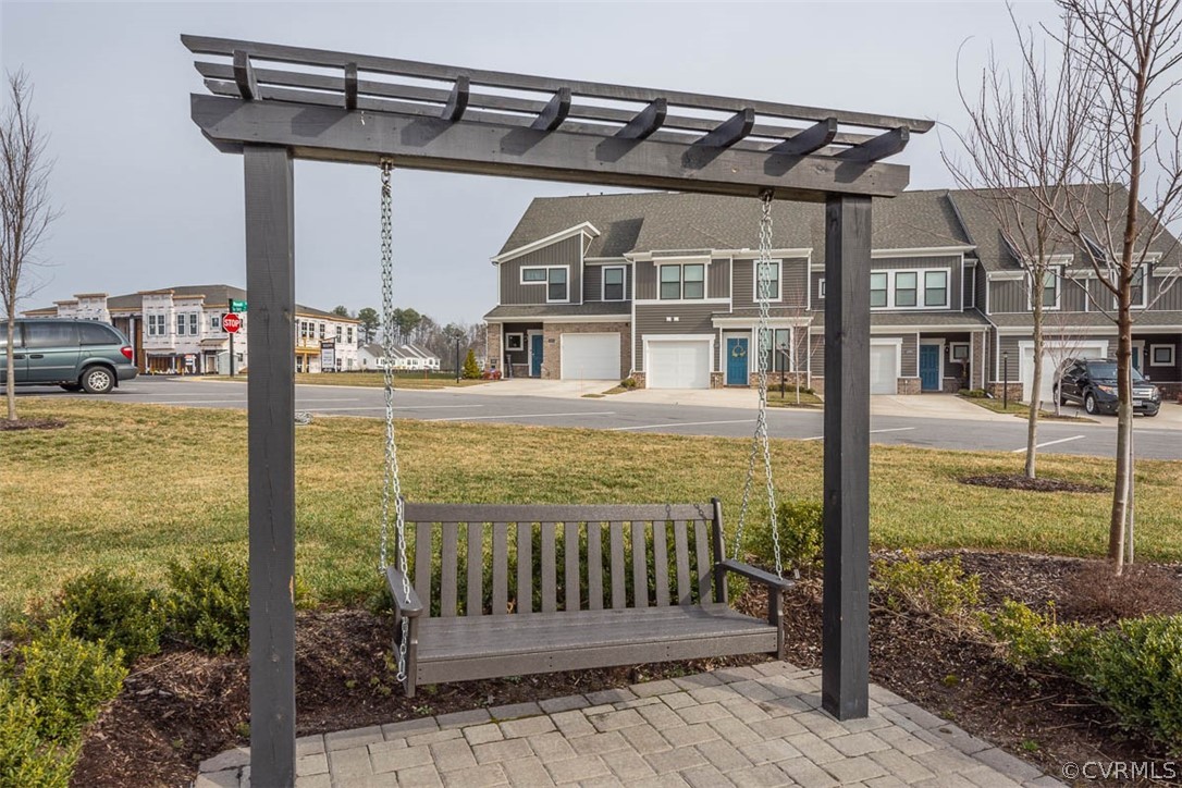 4100 Maze Runner Drive, Unit 406 Midlothian, VA 23112 - Photo 31 of 34 a view of a brick house with a small yard