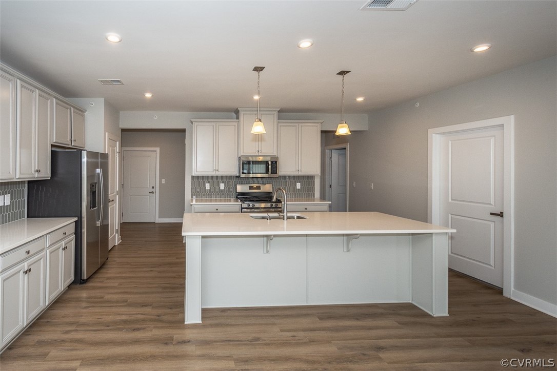 4100 Maze Runner Drive, Unit 406 Midlothian, VA 23112 - Photo 7 of 34 a large kitchen with stainless steel appliances a large counter top a sink and a refrigerator