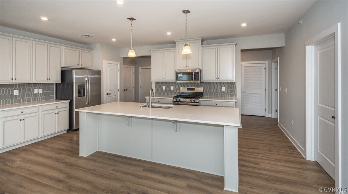 4100 Maze Runner Drive, Unit 406 Midlothian, VA 23112 - Photo 8 of 34 a kitchen with kitchen island a sink stainless steel appliances and cabinets