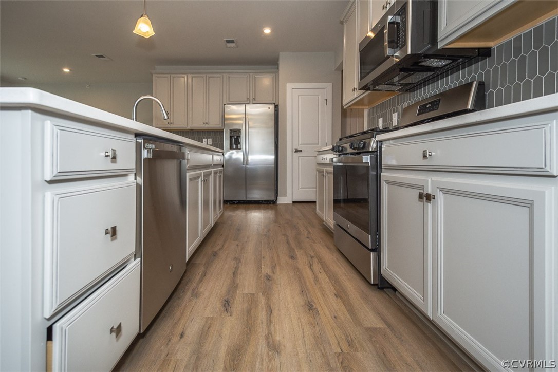 4100 Maze Runner Drive, Unit 406 Midlothian, VA 23112 - Photo 9 of 34 a view of a kitchen with refrigerator and wooden floor
