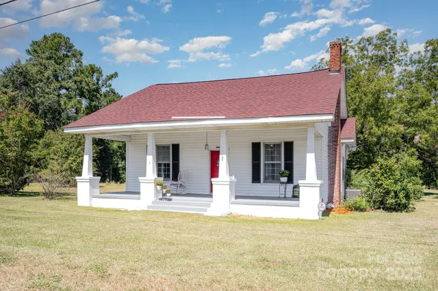 a view of a house with floor to ceiling windows and a basket ball poll