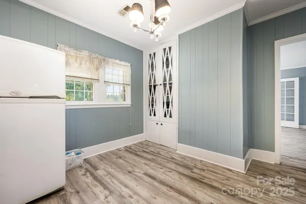 a view of a bedroom with wooden floor and a window