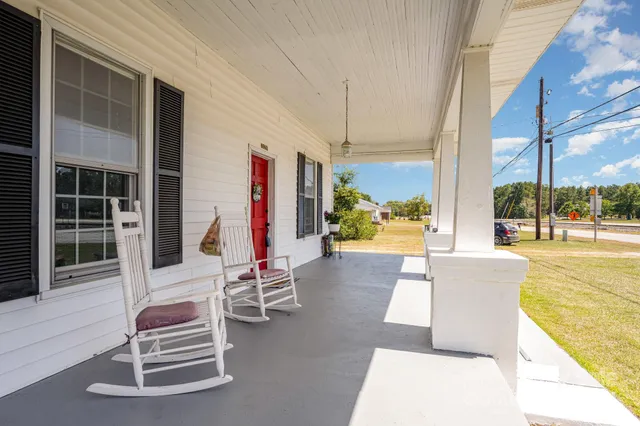 a balcony with furniture and a potted plant