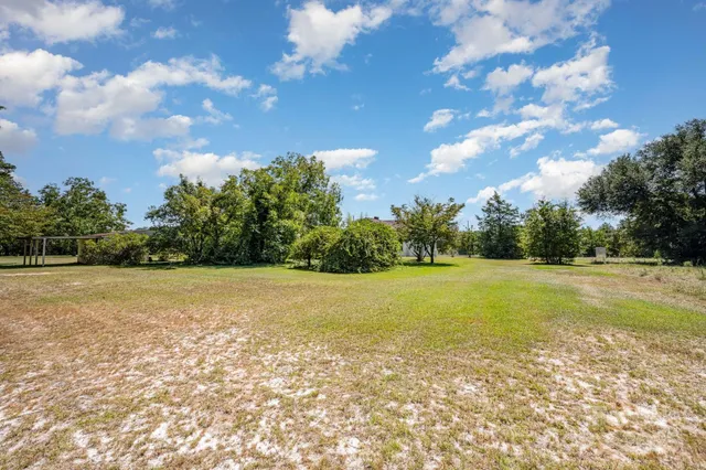 a backyard of a house with yard and outdoor seating