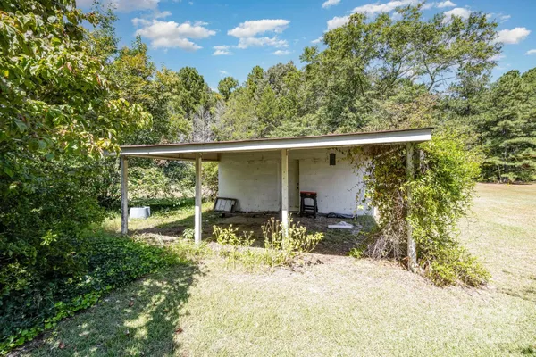 a view of a house with pool and a yard