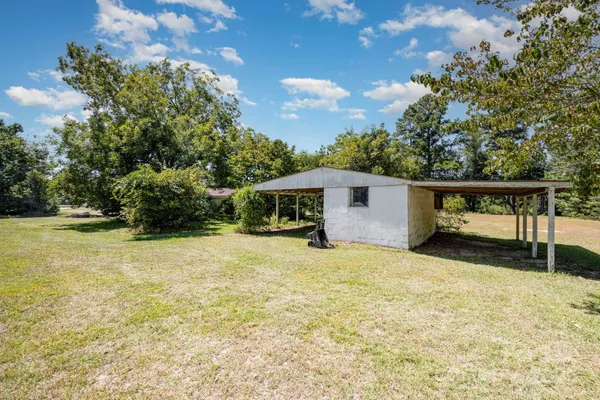 a big yard with lots of green space and trees
