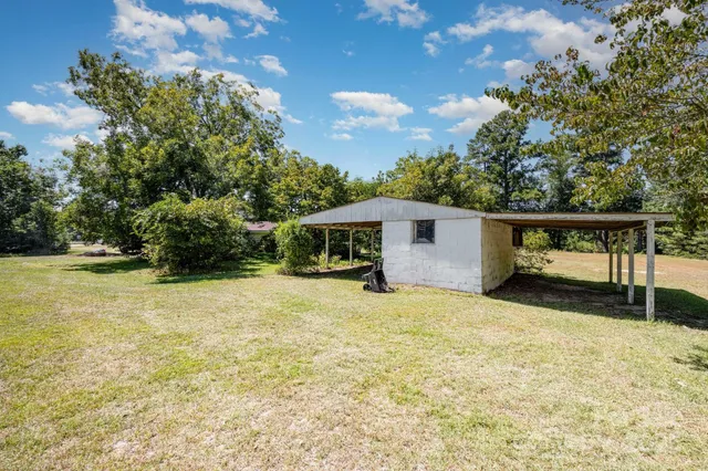 a big yard with lots of green space and trees