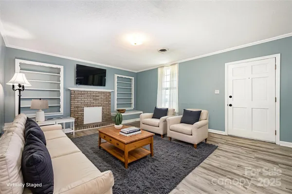 a living room with furniture fireplace and a flat screen tv