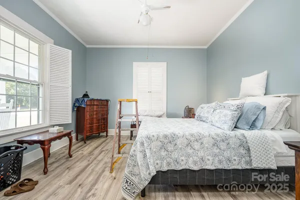 a living room with a bed furniture and a large window