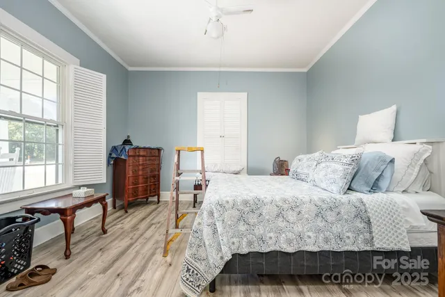 a living room with a bed furniture and a large window