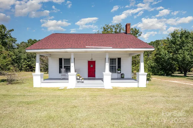 a view of house with outdoor space and swimming pool