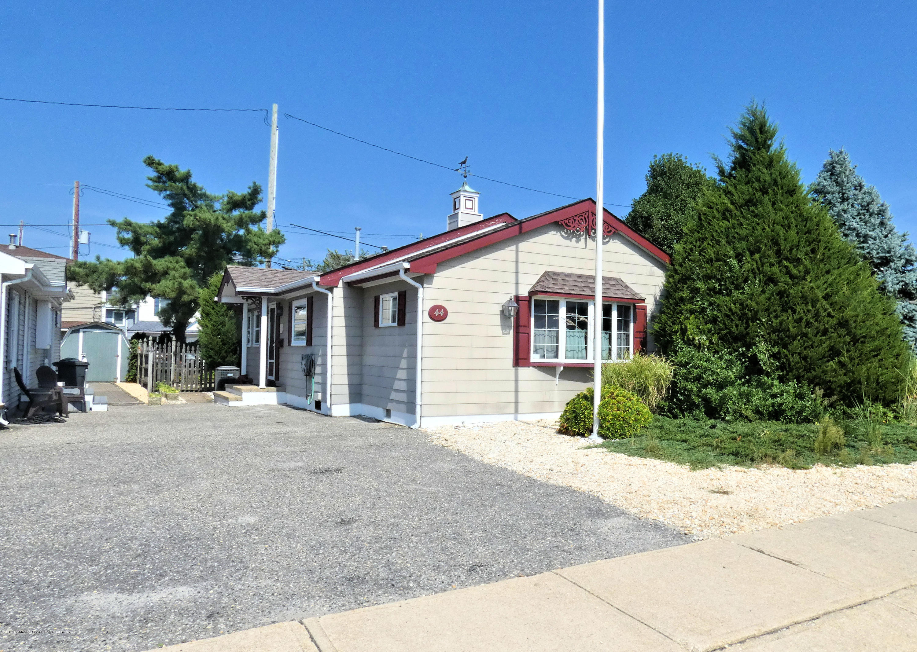 44 Las Vegas Road Lavallette, NJ 08735 - Photo 1 of 18 a front view of a house with a yard and potted plants