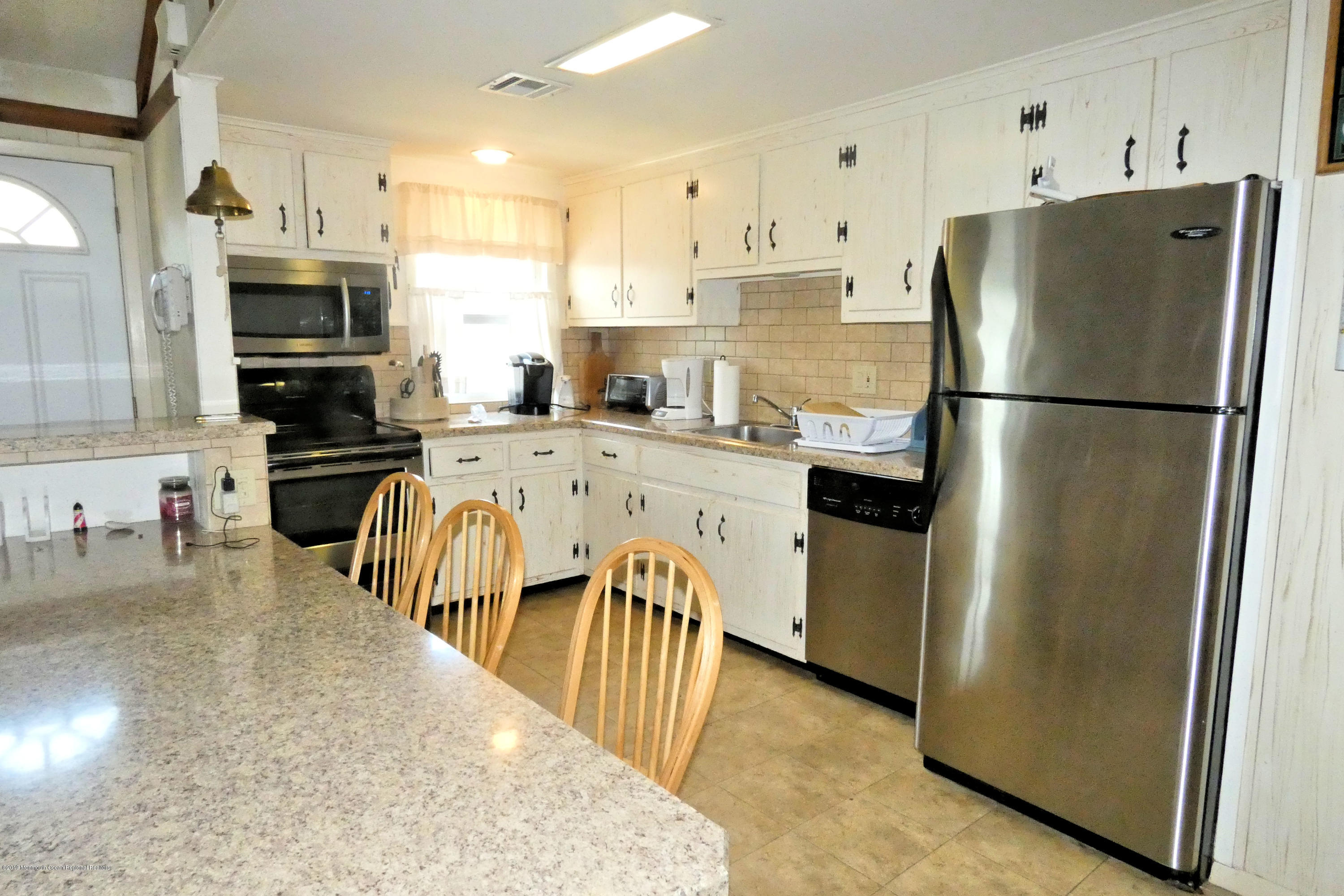 44 Las Vegas Road Lavallette, NJ 08735 - Photo 6 of 18 a kitchen with stainless steel appliances a refrigerator stove microwave and cabinets
