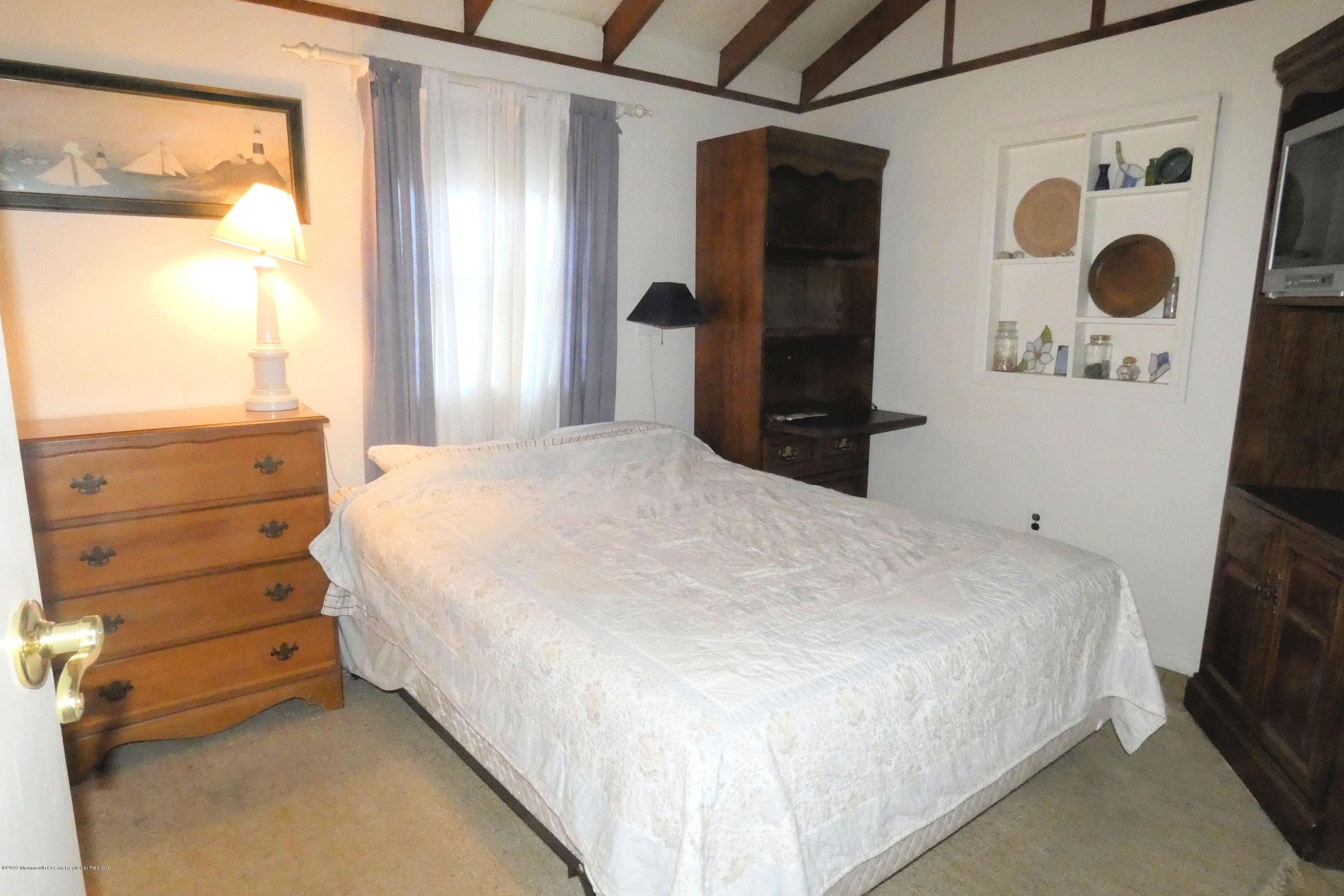 44 Las Vegas Road Lavallette, NJ 08735 - Photo 9 of 18 a bedroom with a bed and a window