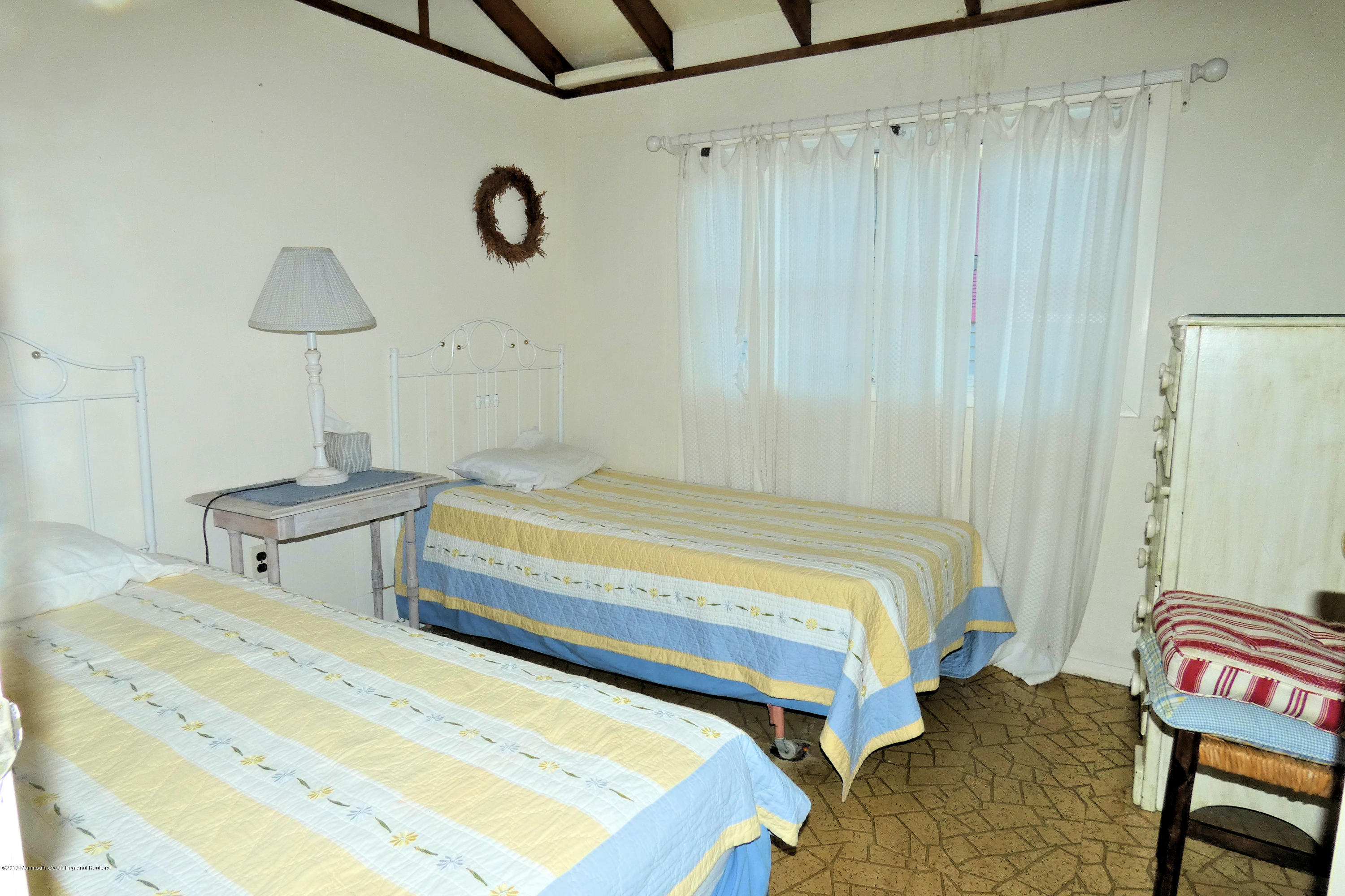 44 Las Vegas Road Lavallette, NJ 08735 - Photo 10 of 18 a bedroom with a bed and a table in it