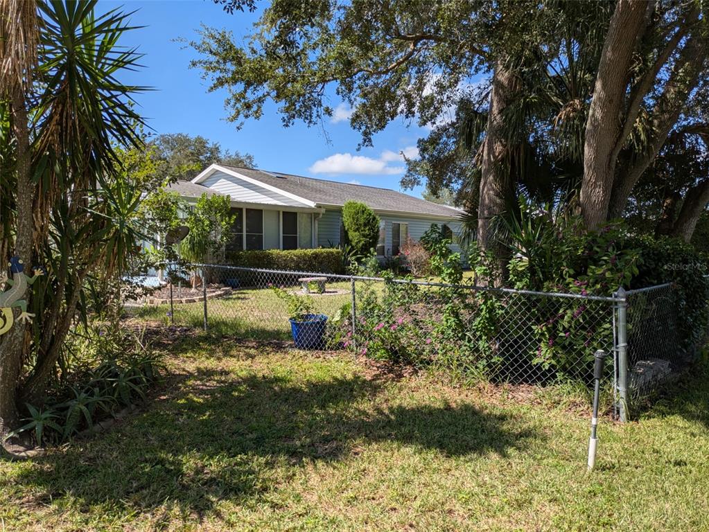 9499 Southeast 174th Loop Summerfield, FL 34491 - Photo 13 of 46 a front view of a house with a yard