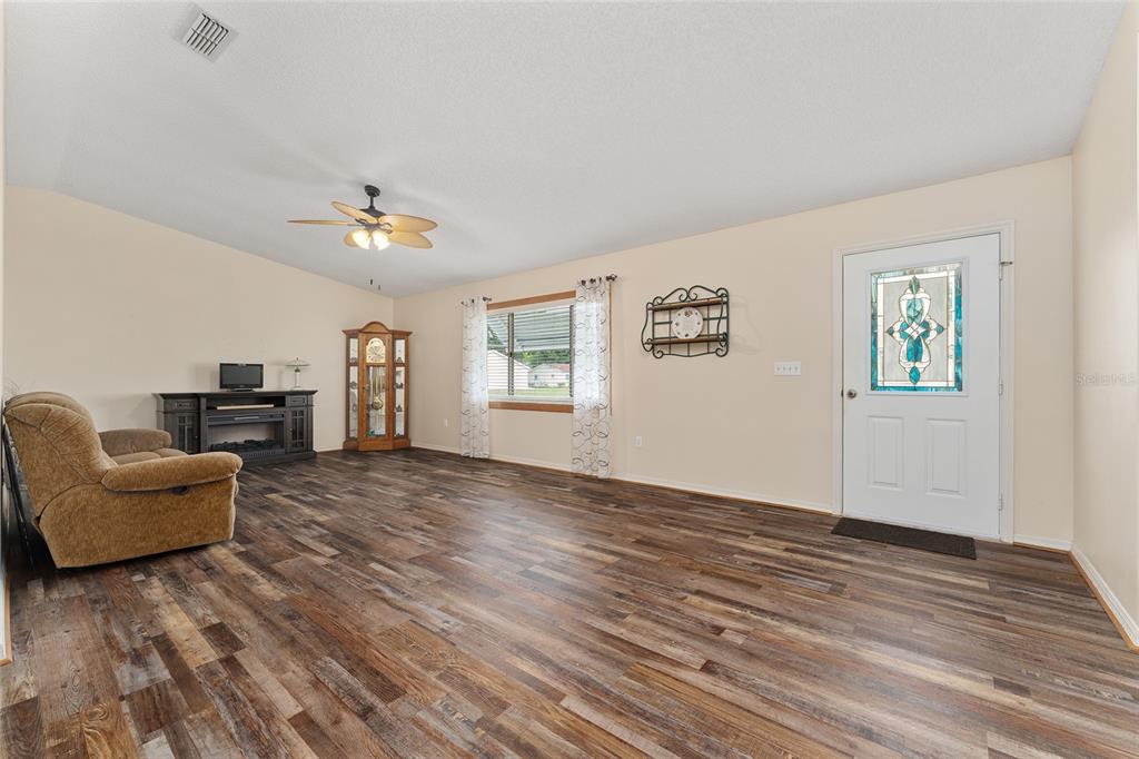 9499 Southeast 174th Loop Summerfield, FL 34491 - Photo 17 of 46 a living room with furniture and a wooden floor