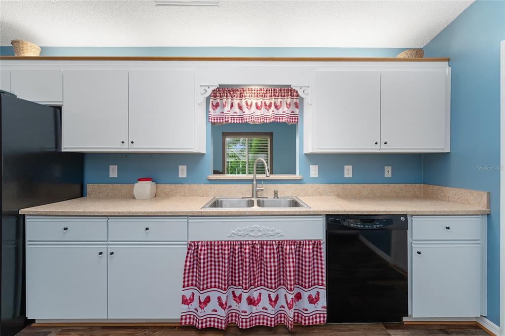 9499 Southeast 174th Loop Summerfield, FL 34491 - Photo 27 of 46 a kitchen with a sink cabinets and window