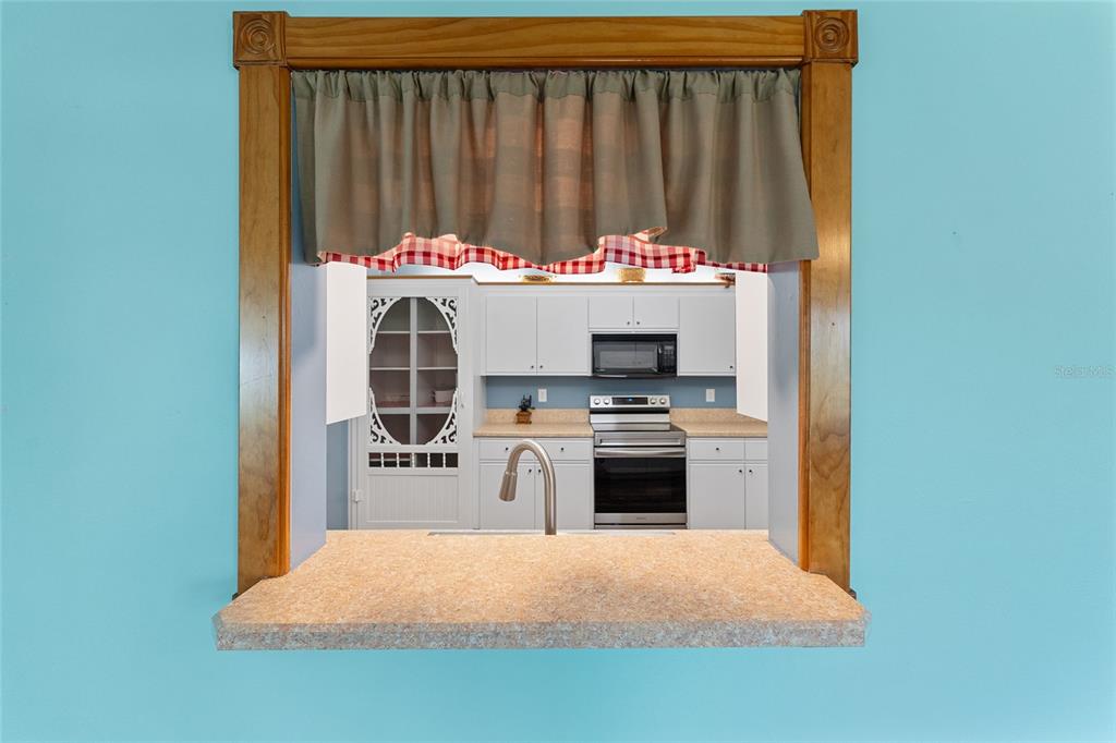 9499 Southeast 174th Loop Summerfield, FL 34491 - Photo 28 of 46 a kitchen with a stove and a refrigerator