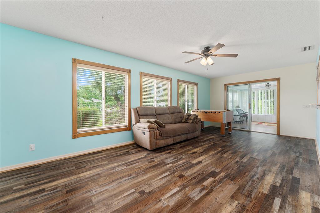 9499 Southeast 174th Loop Summerfield, FL 34491 - Photo 29 of 46 a living room with furniture and a chandelier